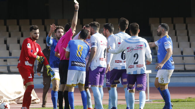 Los jugadores del XCD y del Ciudad de Lucena rodean al árbitro para protestarle tras el penalti de Espejo.