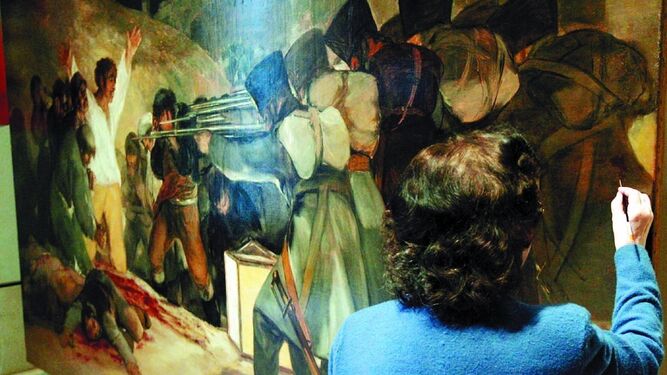 Ejemplo de restauración profesional en los talleres del Prado del célebre cuadro de Goya 'Los fusilamientos'.