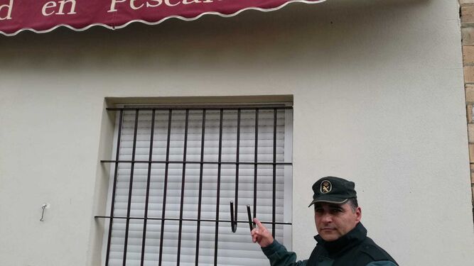 El agente Luis Miguel Larbi, ya vestido de guardia civil, ante la ventana reventada de Paterna