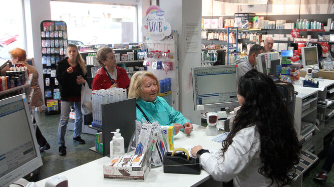 Varias mujeres en la cola de una farmacia en Huelva.