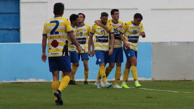 Los futbolistas del Coria felicitan a Juan Gómez (11), autor del gol en el Barbadillo.