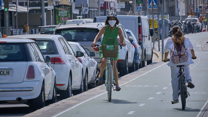 Personas con mascarillas por el carril bici en Cádiz.