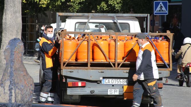 Dos trabajadores con el camión de reparto de butano en la calle Larga