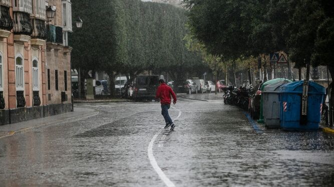 Una persona camina bajo la lluvia en Cádiz.