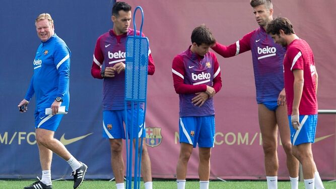Ronald Koeman observa a sus jugadores en el entrenamiento matinal de ayer en la ciudad deportiva barcelonista.