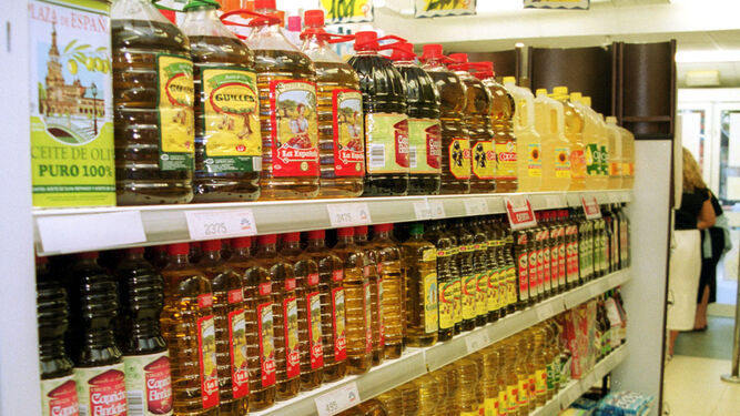 Aceite  de  oliva embotellado, en el estante de  un supermercado.
