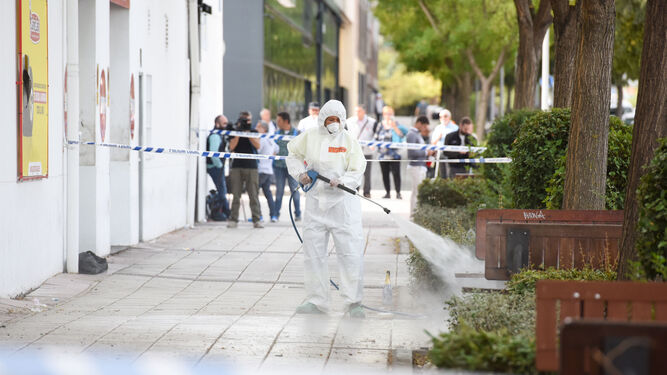 Una mujer limpia la zona del tiroteo en Fuenlabrada.